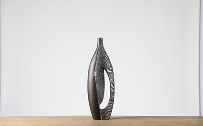 Modern sculptural, tribal-inspired, and contemporary luxury,Asymmetrical, Openwork Design