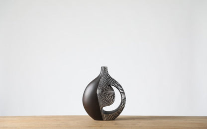 Modern sculptural, tribal-inspired,contemporary luxury,Asymmetrical, Openwork Design